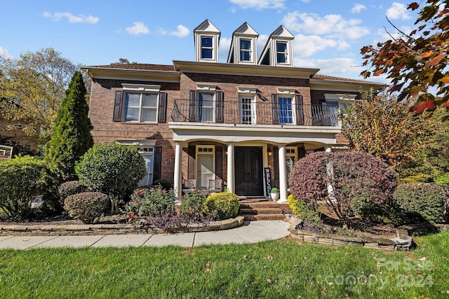 view of front of home with a porch and a balcony