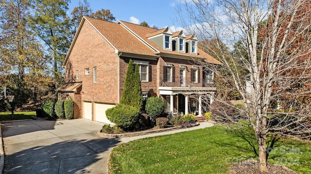 view of front facade with a front yard and a garage