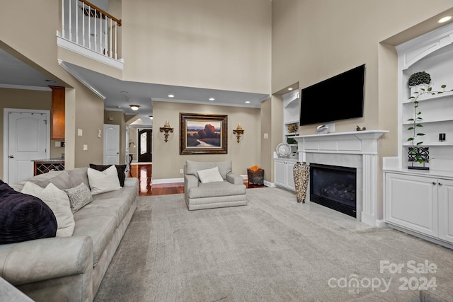 living room with light colored carpet, crown molding, and a high ceiling