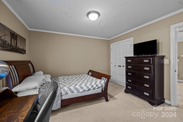 bedroom with a closet, light colored carpet, and ornamental molding