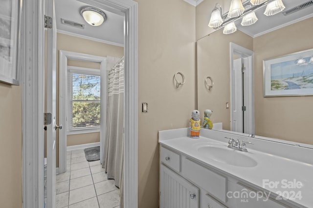 bathroom featuring tile patterned flooring, vanity, and crown molding