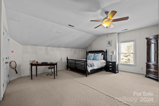 carpeted bedroom with ceiling fan and vaulted ceiling