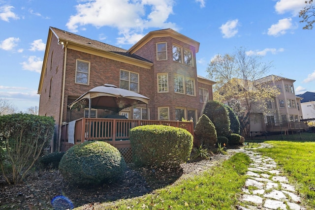 back of house featuring a wooden deck