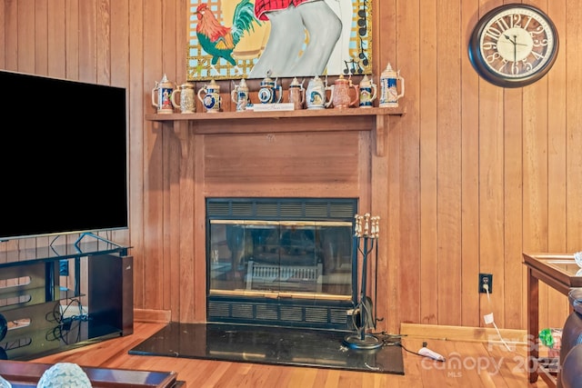 living room with wood walls and hardwood / wood-style flooring