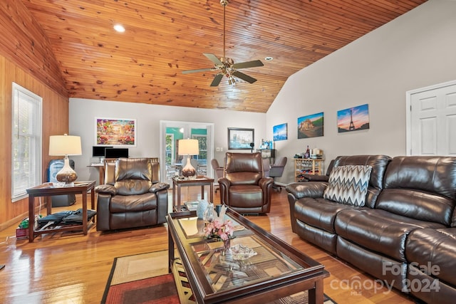 living room with wooden ceiling, a healthy amount of sunlight, light wood-type flooring, and vaulted ceiling