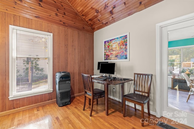 office space featuring wooden ceiling, heating unit, wooden walls, light wood-type flooring, and vaulted ceiling