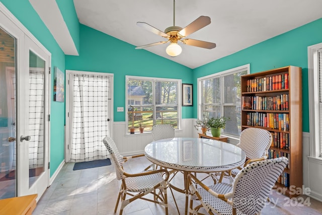 tiled dining area with lofted ceiling, french doors, and ceiling fan