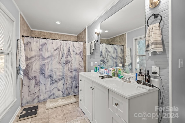 bathroom featuring vanity, walk in shower, a healthy amount of sunlight, and crown molding