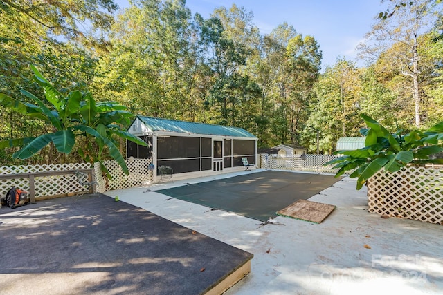 view of pool featuring a patio and a sunroom