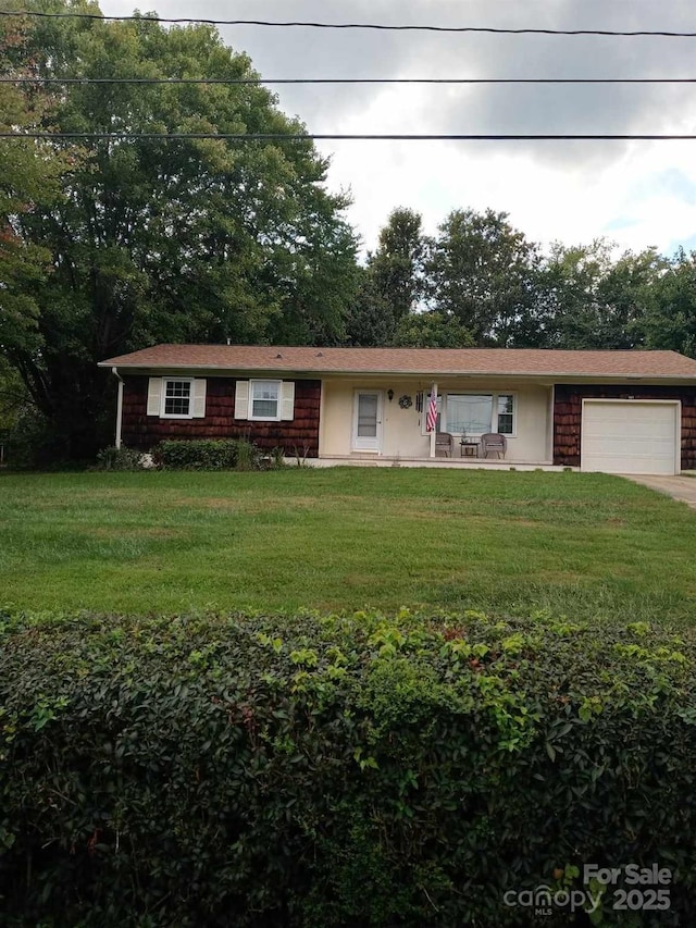 single story home featuring a front yard and a garage