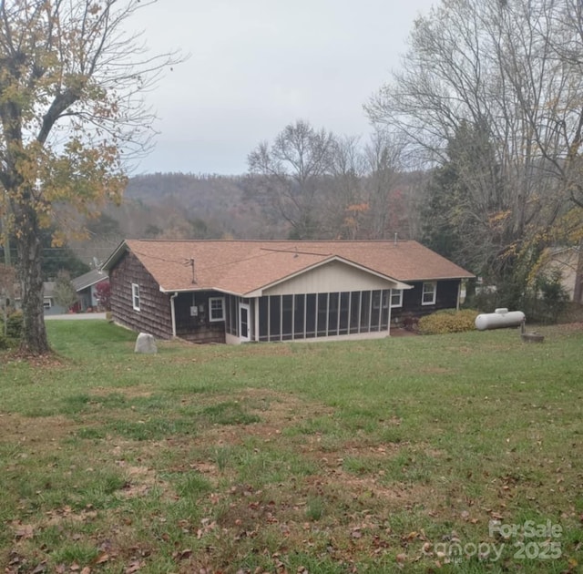 back of house with a sunroom and a yard