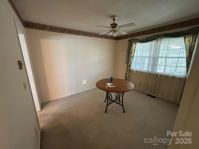 interior space with carpet floors and ceiling fan