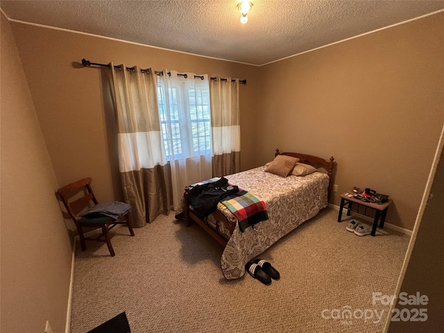 bedroom featuring carpet floors and a textured ceiling