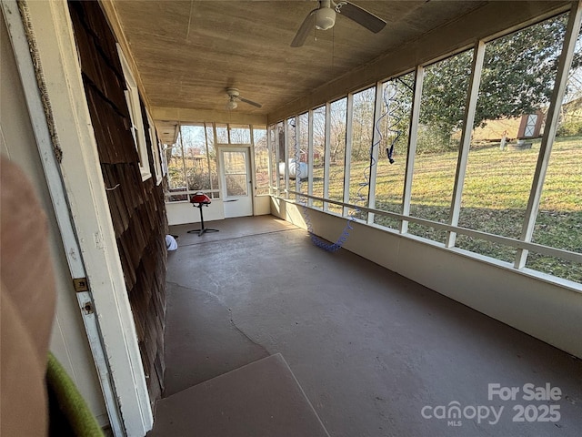 unfurnished sunroom with wood ceiling