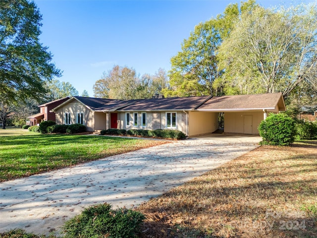 ranch-style home featuring a front yard and a carport