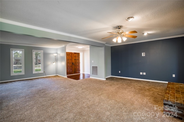 carpeted spare room with ornamental molding, a textured ceiling, and ceiling fan