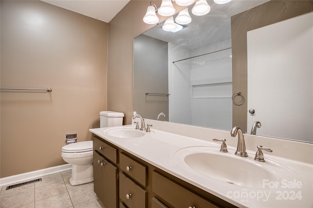 bathroom with vanity, tile patterned floors, and toilet