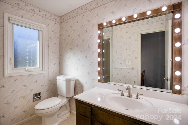 bathroom featuring toilet, vanity, and tile patterned floors