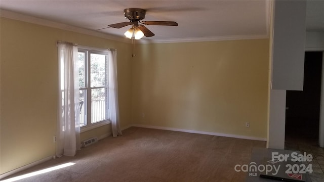 unfurnished room featuring ceiling fan and ornamental molding