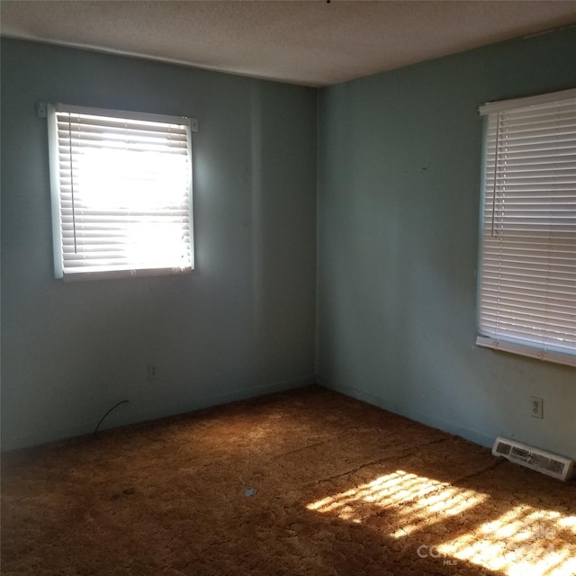 unfurnished room featuring a textured ceiling