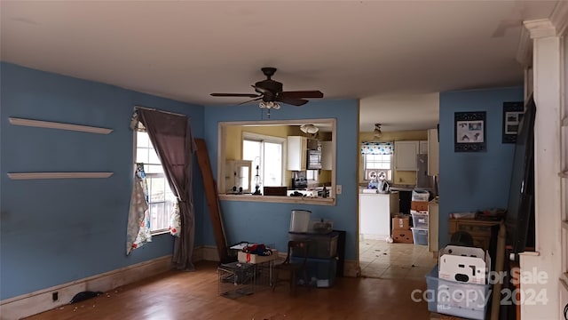 living room featuring ceiling fan and hardwood / wood-style floors