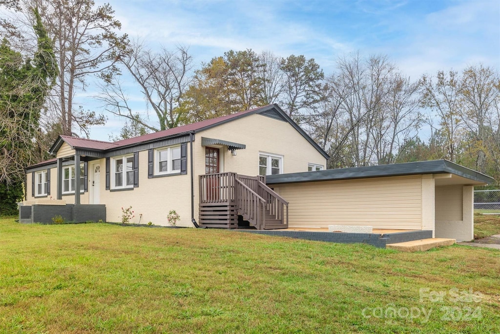 rear view of property with a yard