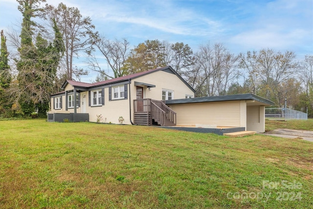 rear view of property featuring a lawn