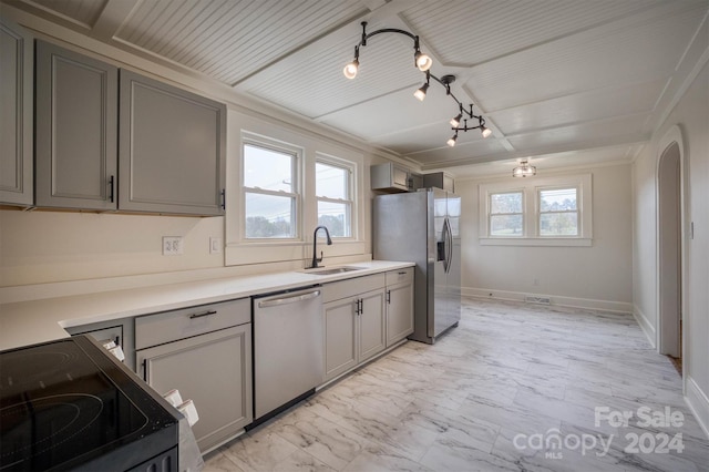 kitchen with a wealth of natural light, stainless steel appliances, and gray cabinetry