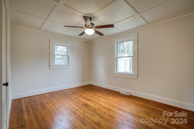 unfurnished room featuring crown molding, plenty of natural light, hardwood / wood-style flooring, and ceiling fan