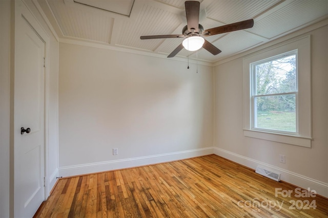 empty room featuring light wood-type flooring, ceiling fan, and crown molding