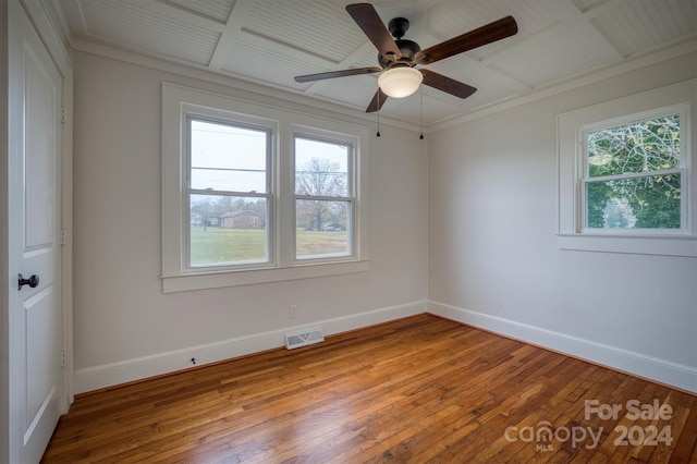 spare room featuring hardwood / wood-style floors, a wealth of natural light, ceiling fan, and crown molding