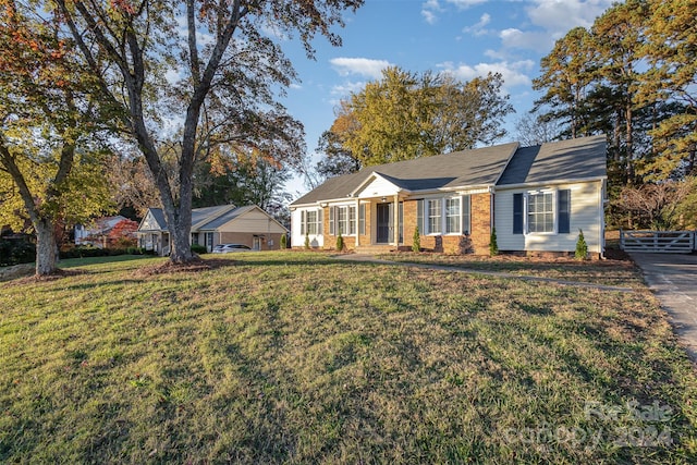 ranch-style home with a front lawn