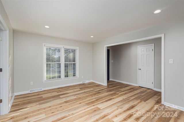 unfurnished room with light wood-type flooring