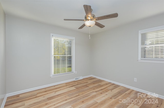 unfurnished room with ceiling fan and light wood-type flooring