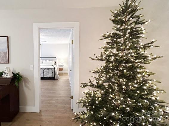 corridor with hardwood / wood-style flooring