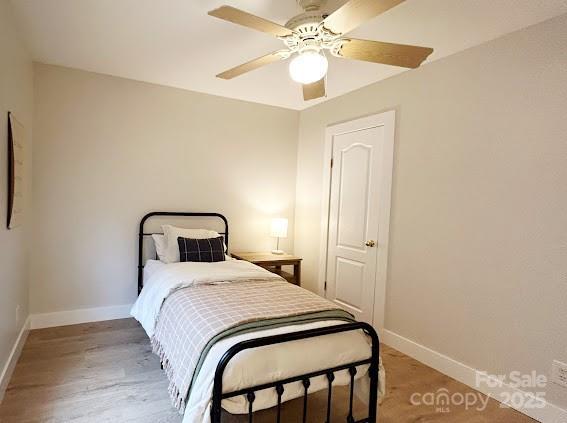 bedroom with ceiling fan and wood-type flooring