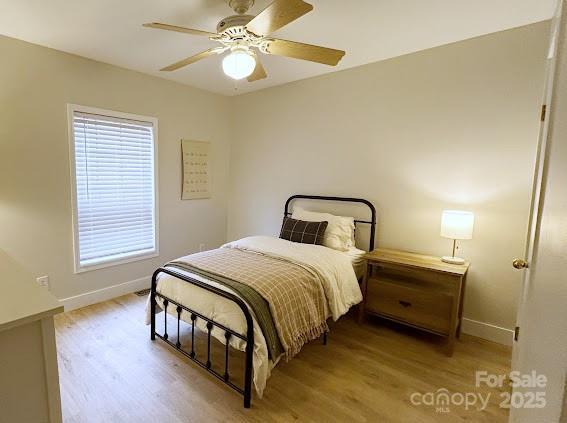 bedroom with light hardwood / wood-style floors and ceiling fan