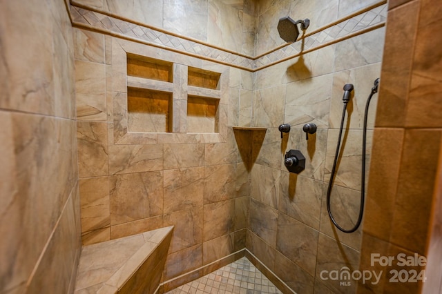 bathroom with tiled shower