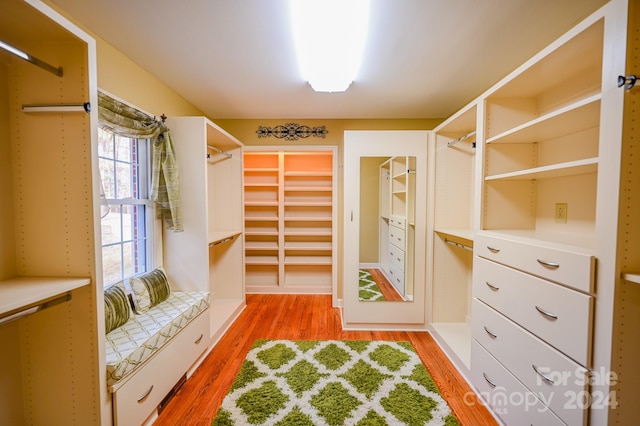 walk in closet featuring hardwood / wood-style flooring