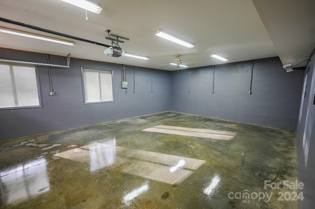 garage featuring ceiling fan and a garage door opener