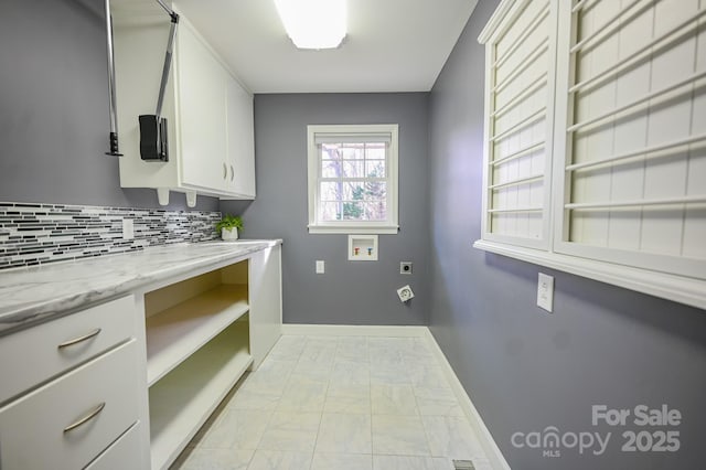 183 Creekside Dr, Forest City, NC 28043 - clothes washing area with cabinet space, light marble finish floors, washer hookup, hookup for an electric dryer, and baseboards
