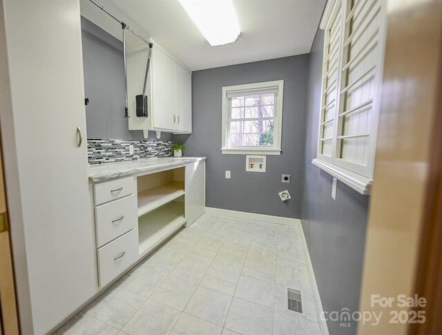 183 Creekside Dr, Forest City, NC 28043 - clothes washing area with electric dryer hookup, hookup for a washing machine, light marble finish floors, cabinet space, and baseboards