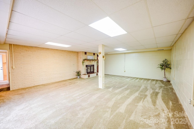 183 Creekside Dr, Forest City, NC 28043 - finished below grade area with carpet flooring, a fireplace, a paneled ceiling, brick wall, and concrete block wall