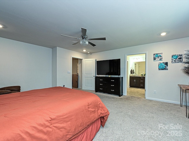 bedroom featuring ceiling fan, light carpet, and connected bathroom