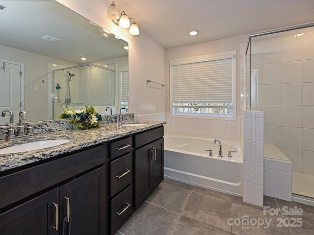 bathroom with plus walk in shower, vanity, and tile patterned flooring