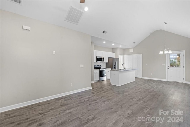 unfurnished living room with sink, high vaulted ceiling, dark wood-type flooring, and an inviting chandelier