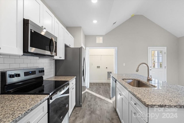 kitchen with sink, white cabinets, light wood-type flooring, and appliances with stainless steel finishes