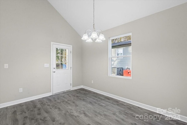 interior space featuring high vaulted ceiling, dark wood-type flooring, and an inviting chandelier