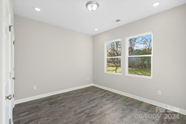 unfurnished room with dark hardwood / wood-style floors