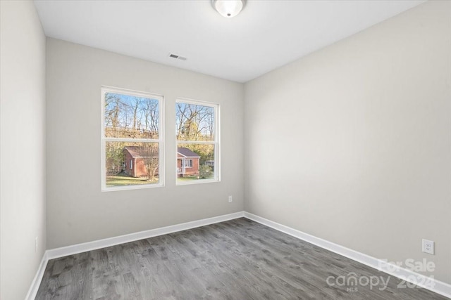 unfurnished room with wood-type flooring